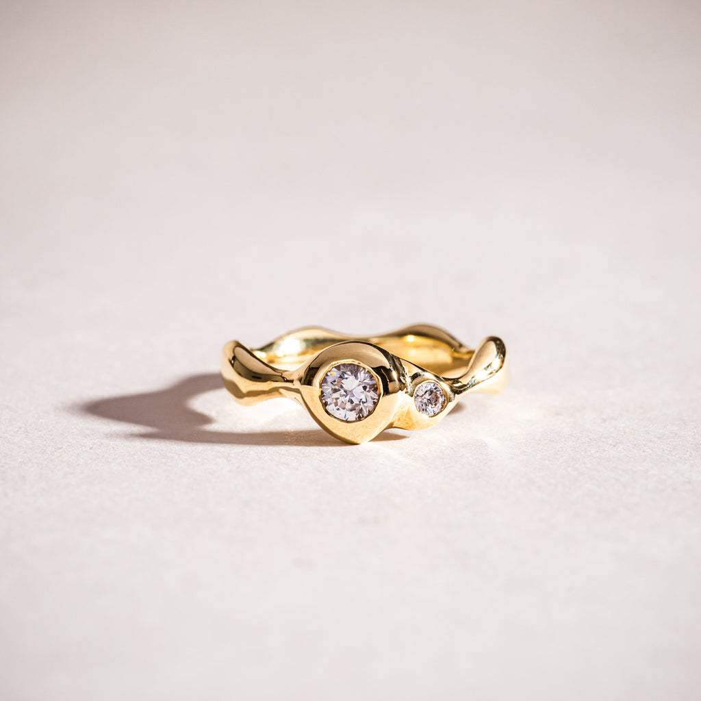 Polished wavy gold and diamond ring 