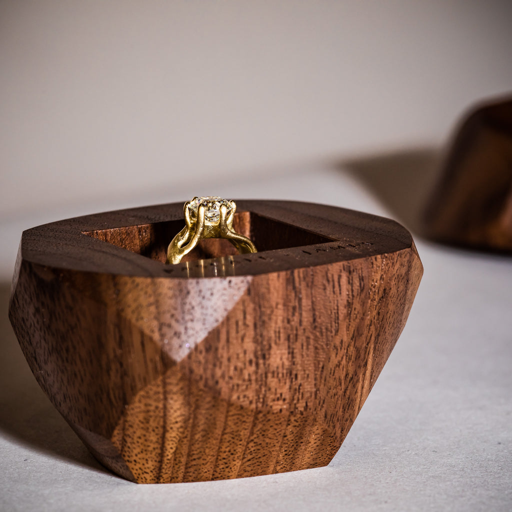 Diamond engagement ring in 18ct Fairtrade yellow fold and weaving organic branches sat inside a wooden engagement ring box