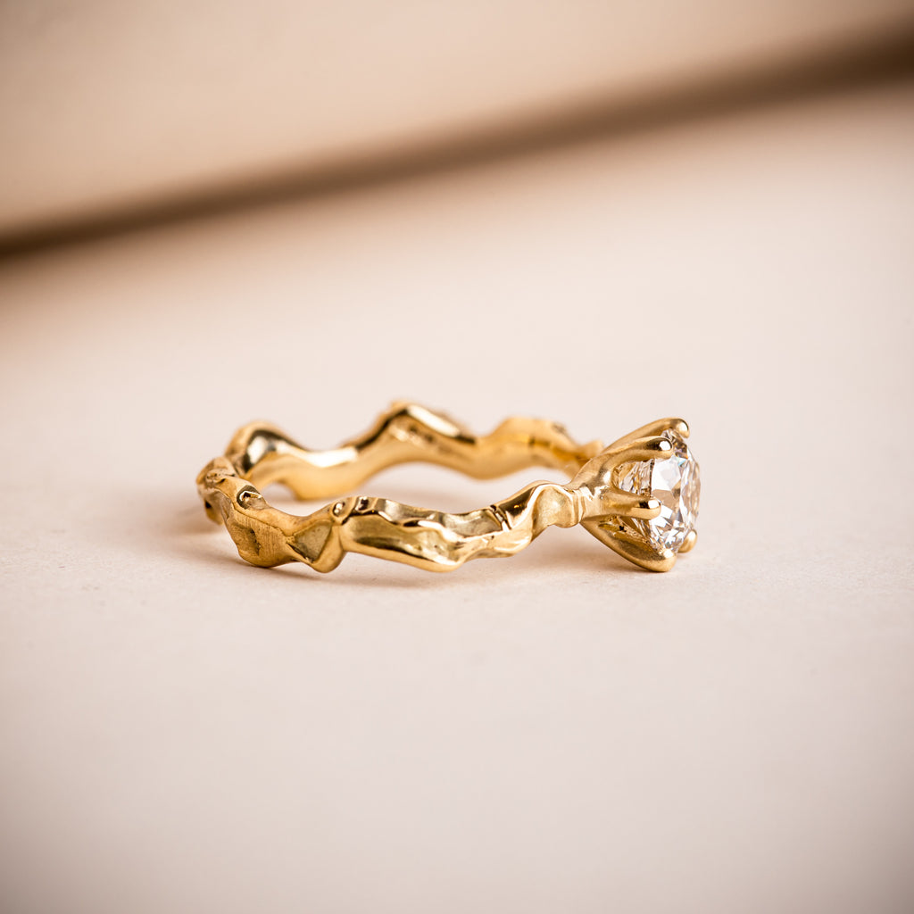 Sculptural and textured wavy 18ct yellow gold engagement ring with Canadian brilliant round diamond