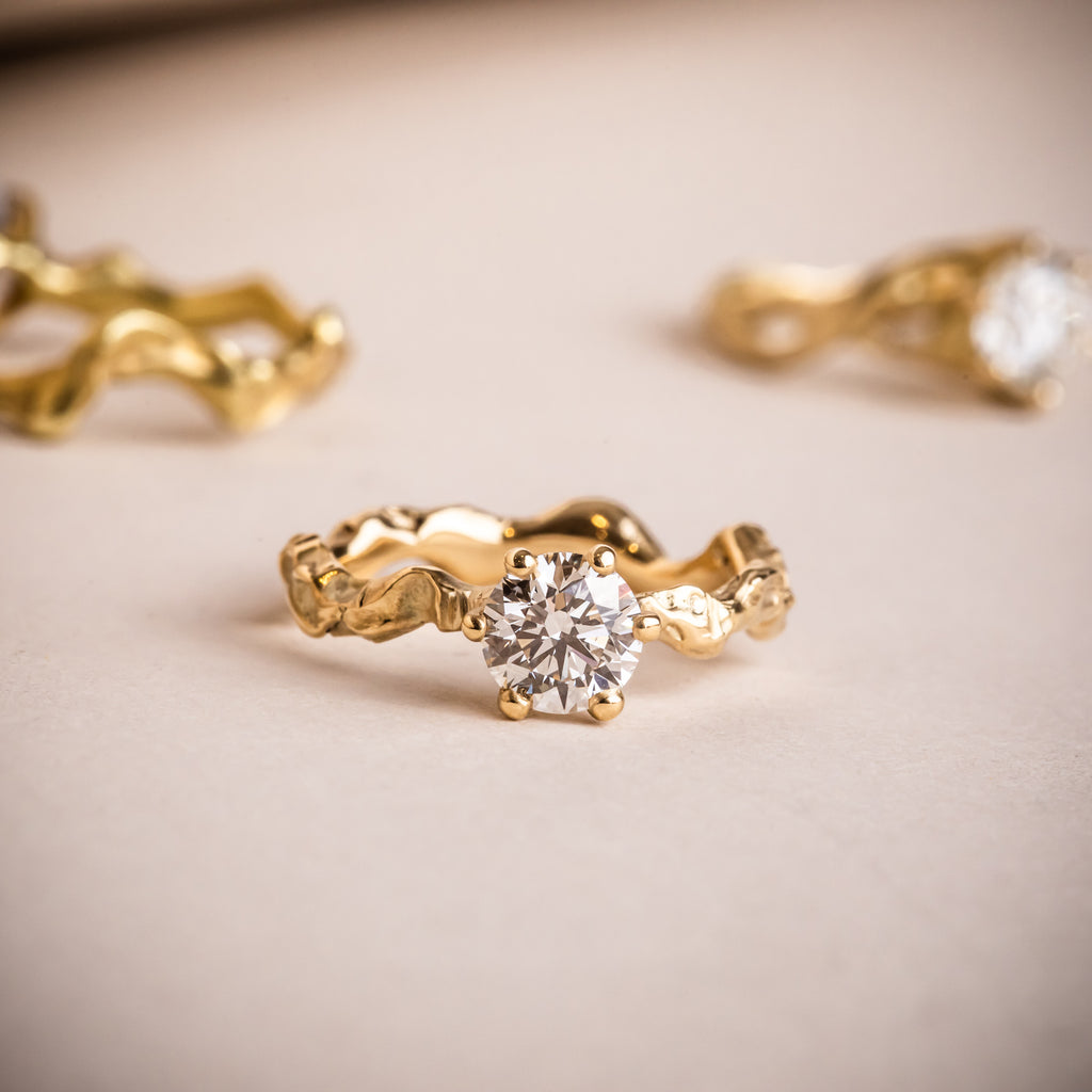 A selection of sculptural 18ct yellow gold engagement rings with Canadamark Canadian diamonds
