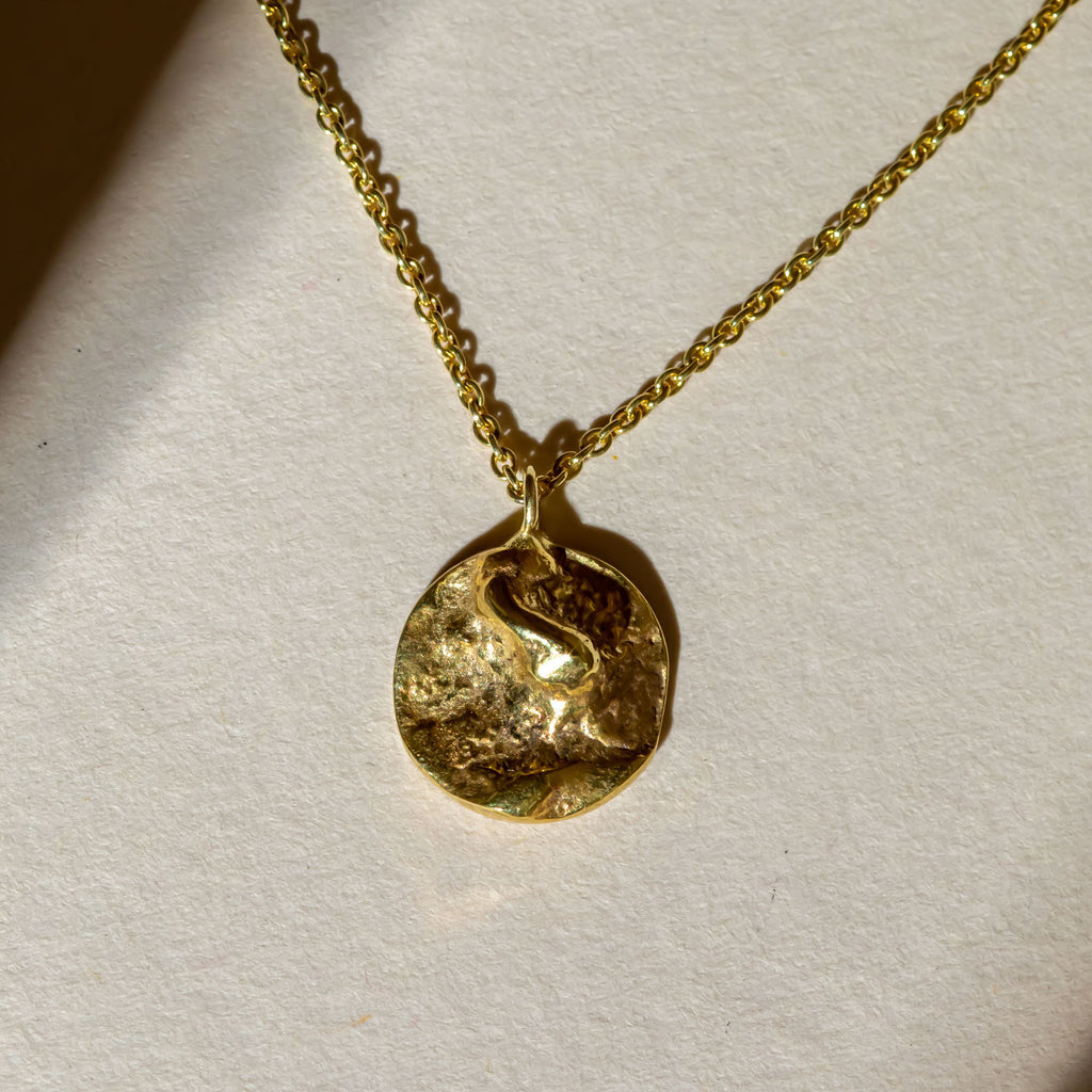 Small yellow gold disc shaped moon pendant necklace
