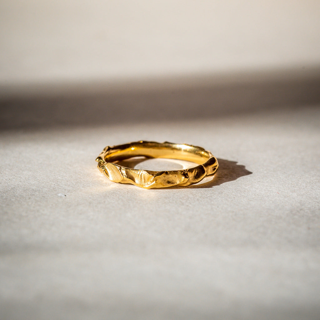 Narrow 18ct Fairtrade gold textured wedding band 