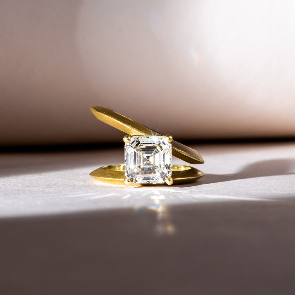 Asscher diamond set into a tilted gold band
