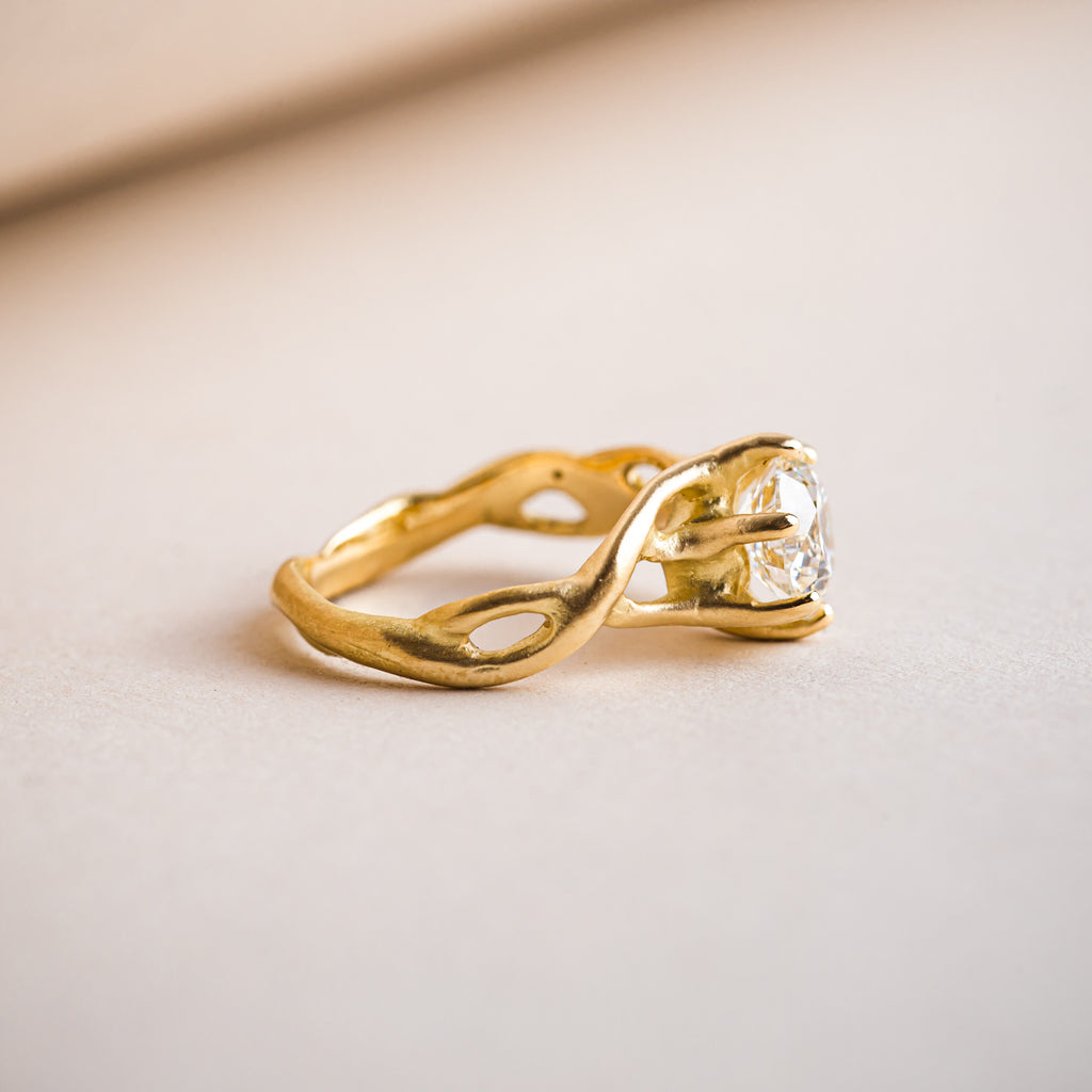 Organic branch like entwined 18ct yellow gold ring that weaves around a Canadian brilliant round diamond