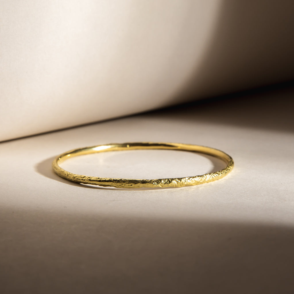 Textured, organic 18ct yellow gold fine bangle