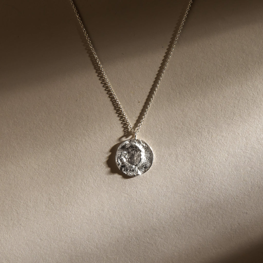 Textured silver moon pendant