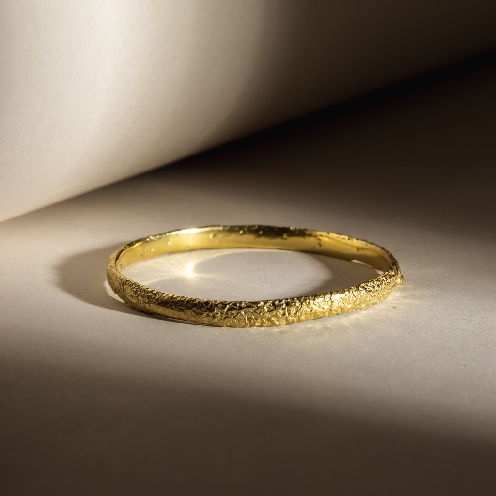 Textured, organic 18ct yellow gold stacking bangle