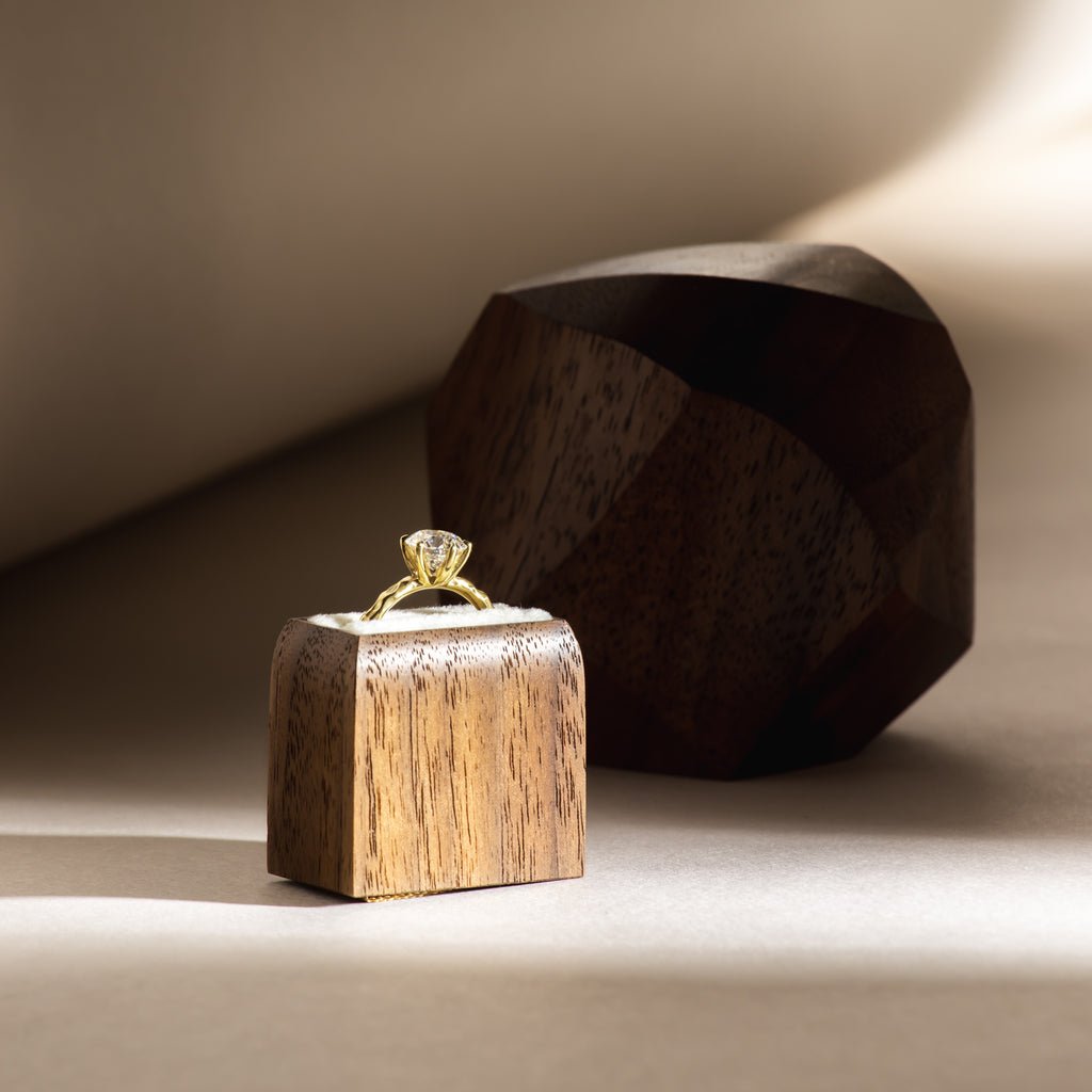 Unusual diamond solitaire ring in handcarved wooden ring box