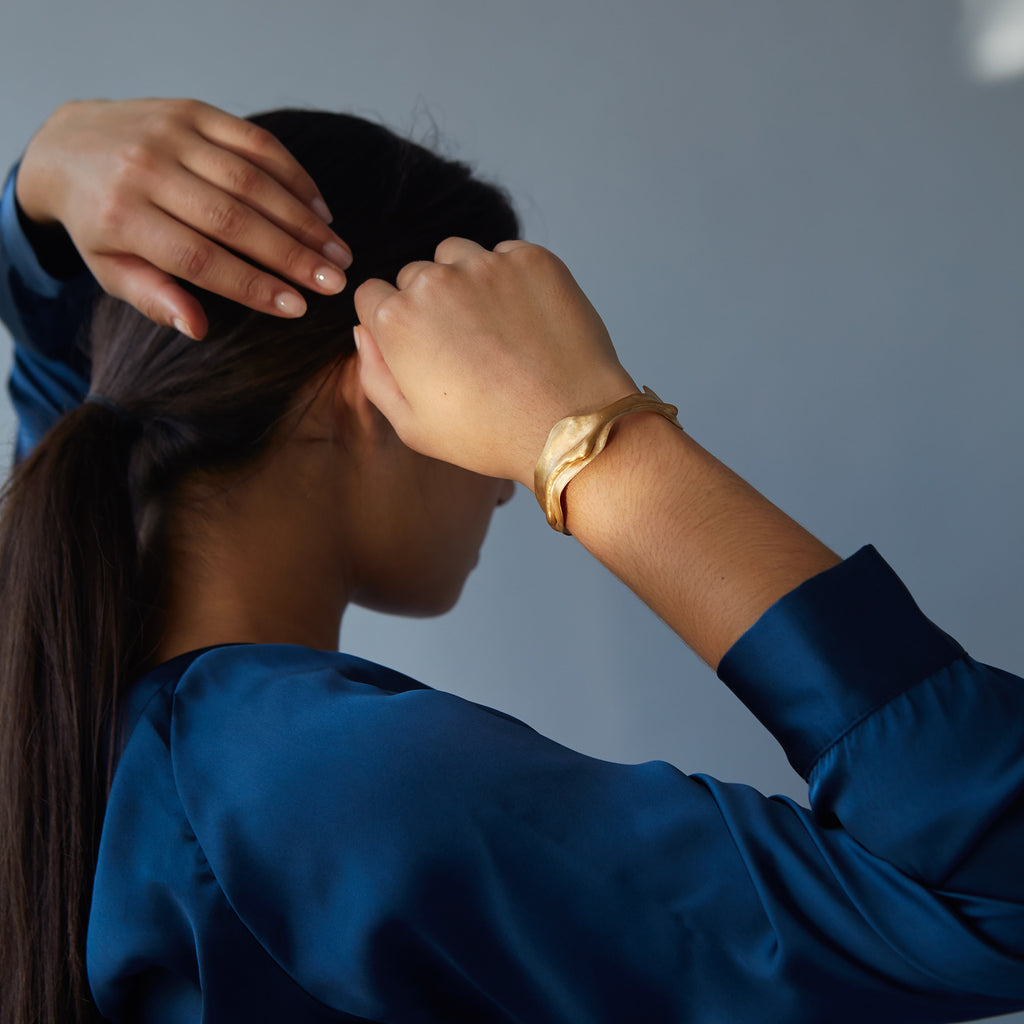 Gold bangle with wave detail